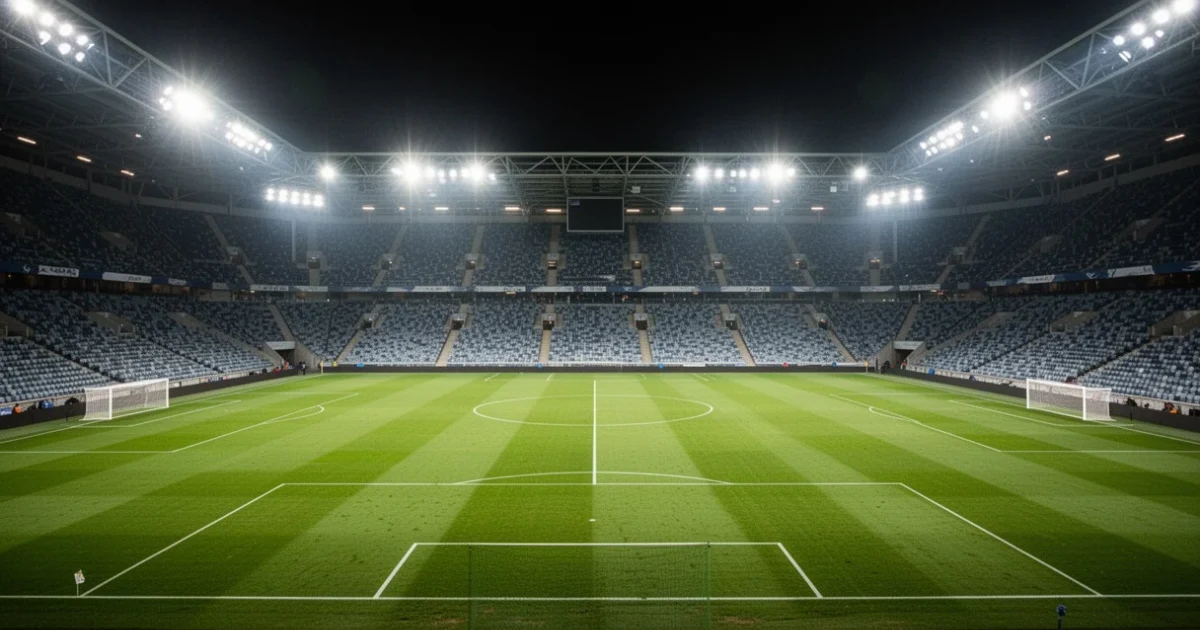 Estadio vacío iluminado por luces brillantes durante la noche